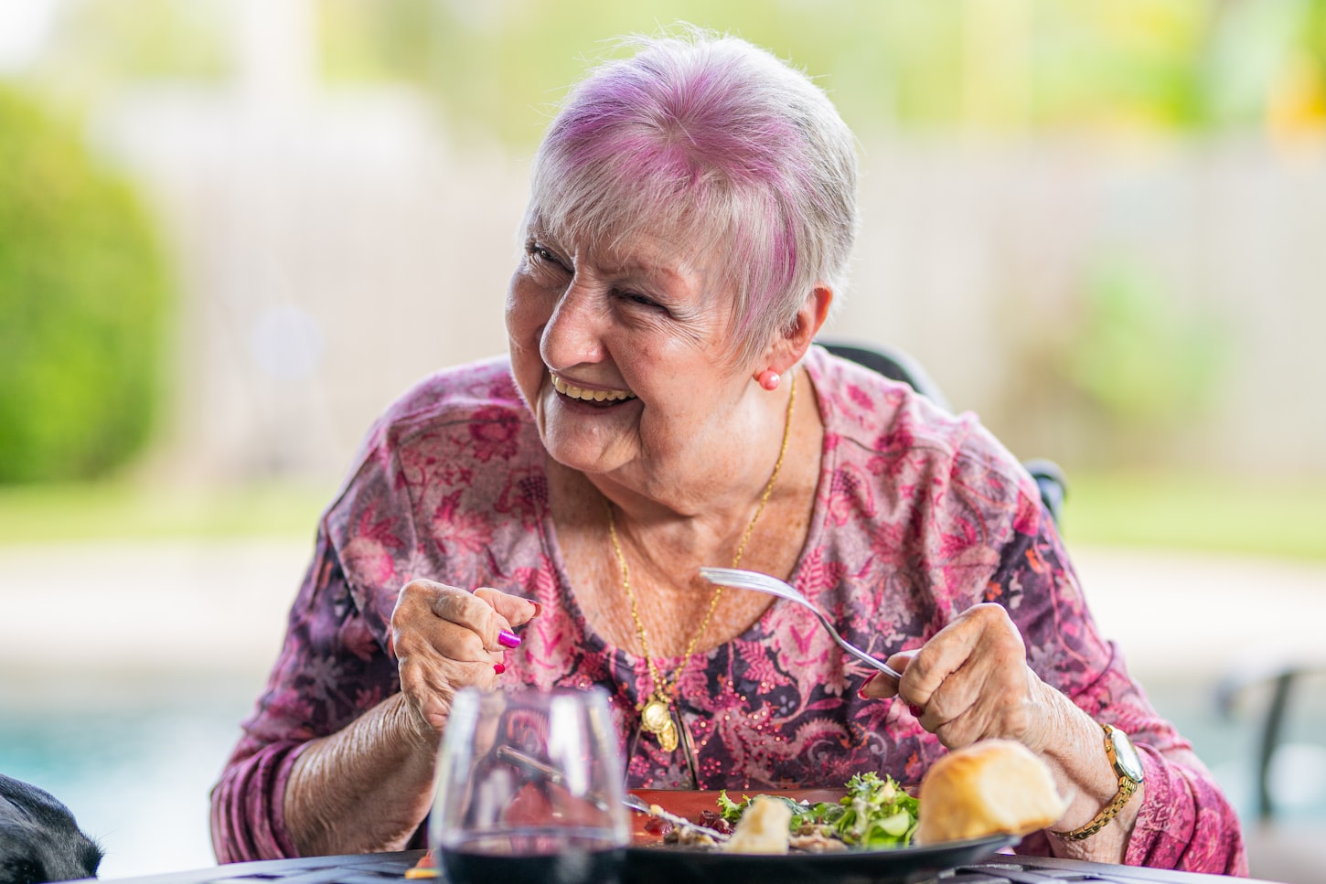Smiling homebound senior enjoying a meal